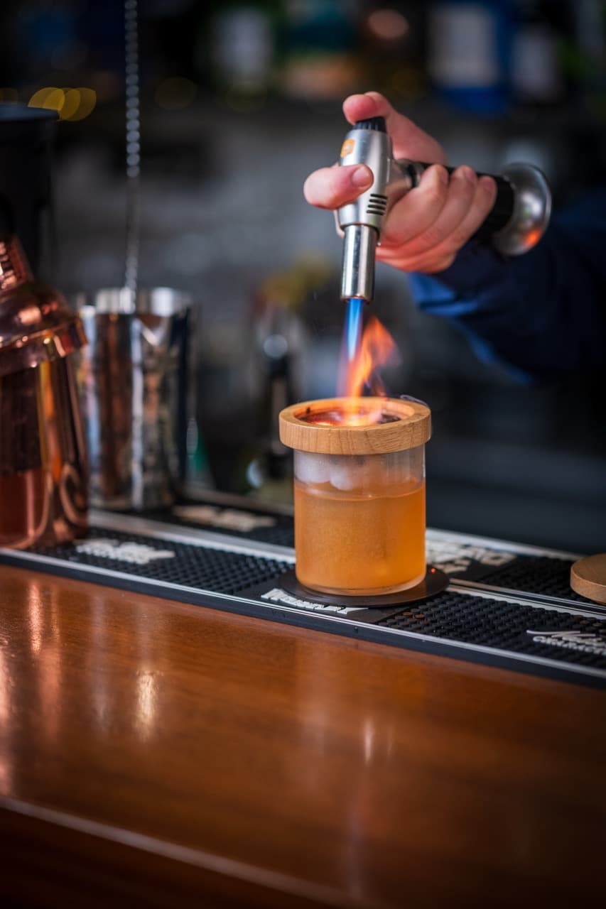 Old Fashioned cocktail twist, showcasing artistic mixology and the glamorous energy of Paceville’s bar culture